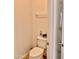 Clean toilet room with neutral walls and flooring, featuring a white toilet and towel rack at 7925 S 52Nd Dr, Laveen, AZ 85339