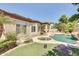 Beautiful backyard featuring a pool, spa, lush landscaping, and a covered patio perfect for outdoor living at 795 W Verbena Ln, Litchfield Park, AZ 85340
