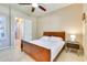 Inviting bedroom with a comfortable bed, a nightstand with a lamp, and a view of the open doorway at 795 W Verbena Ln, Litchfield Park, AZ 85340