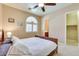 Comfortable bedroom featuring a bed, neutral wall paint, window, and doorway to the bathroom at 795 W Verbena Ln, Litchfield Park, AZ 85340