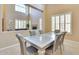 Elegant dining room with a decorative chandelier, a stylish table, and large windows offering plenty of natural light at 795 W Verbena Ln, Litchfield Park, AZ 85340