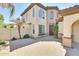 Inviting front entrance with a paver walkway, a mature palm tree, and a solid wood front door with sidelights at 795 W Verbena Ln, Litchfield Park, AZ 85340