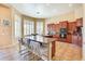 Bright kitchen featuring a large island with seating, granite countertops and stainless appliances at 795 W Verbena Ln, Litchfield Park, AZ 85340