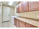 Functional laundry room with a washing machine, dryer, cabinetry, and ample countertop space at 795 W Verbena Ln, Litchfield Park, AZ 85340
