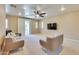 Comfortable living room with neutral walls, a ceiling fan, and a sliding glass door to the balcony at 795 W Verbena Ln, Litchfield Park, AZ 85340