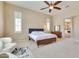 Cozy main bedroom featuring a ceiling fan, neutral walls, and plenty of natural light at 795 W Verbena Ln, Litchfield Park, AZ 85340