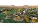 Breathtaking aerial shot of a golf course neighborhood with mountain views and homes nestled among mature trees at 8255 E Vista De Valle --, Scottsdale, AZ 85255