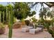 Tranquil patio seating area with desert landscape featuring lounge chairs and cacti at 8255 E Vista De Valle --, Scottsdale, AZ 85255