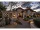 Inviting front entrance featuring a decorative wood door and lush desert landscaping at 8255 E Vista De Valle --, Scottsdale, AZ 85255
