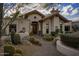 Inviting front entrance featuring a decorative wood door and lush desert landscaping at 8255 E Vista De Valle --, Scottsdale, AZ 85255