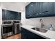 Modern laundry room with stainless steel sink, countertops, and washer and dryer at 8255 E Vista De Valle --, Scottsdale, AZ 85255