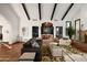 Open-concept living room with beamed ceilings, terracotta tile flooring, and view of the dining room at 8255 E Vista De Valle --, Scottsdale, AZ 85255