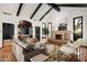 Open living room with beamed ceilings, a stone fireplace, and a dining room in the background at 8255 E Vista De Valle --, Scottsdale, AZ 85255