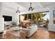 Bright living room with terracotta floors, a modern fireplace, and sliding doors leading to the patio at 8255 E Vista De Valle --, Scottsdale, AZ 85255
