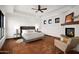 Bright main bedroom boasts terracotta floors, ceiling fan, and decorative fireplace at 8255 E Vista De Valle --, Scottsdale, AZ 85255