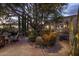 Charming patio area surrounded by mature desert landscaping and trees, creating a private outdoor oasis at 8255 E Vista De Valle --, Scottsdale, AZ 85255