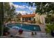 Lush backyard featuring a large pool and covered patio, ideal for enjoying outdoor living and entertaining at 8255 E Vista De Valle --, Scottsdale, AZ 85255