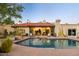 Backyard view of the refreshing swimming pool, desert plants, and home exterior at 8255 E Vista De Valle --, Scottsdale, AZ 85255