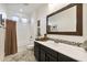 Well-lit bathroom featuring a shower-tub combination with a modern vanity and decorative mirror at 831 E Tonto Pl, Chandler, AZ 85249