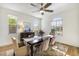 Bright dining room with modern chandelier, large window, hardwood floors, and stylish table setting at 831 E Tonto Pl, Chandler, AZ 85249