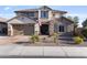 Charming two-story home with a stone accent wall, a manicured front yard, and a two-car garage at 831 E Tonto Pl, Chandler, AZ 85249