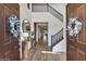 Spacious foyer with high ceilings, wood floors, a staircase, and decorative wreaths on the entry doors at 831 E Tonto Pl, Chandler, AZ 85249