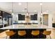 Modern kitchen with stainless steel appliances, large island with bar seating, and dark cabinets at 831 E Tonto Pl, Chandler, AZ 85249