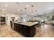 A modern kitchen with a large island that flows into the living room at 831 E Tonto Pl, Chandler, AZ 85249