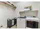 Functional laundry room equipped with modern washer and dryer, and a convenient organization system at 831 E Tonto Pl, Chandler, AZ 85249