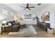 Cozy living room with sectional sofa, ceiling fan, and TV at 831 E Tonto Pl, Chandler, AZ 85249