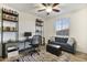 Bright home office featuring built in shelves, modern desk, comfortable seating, and natural light at 831 E Tonto Pl, Chandler, AZ 85249