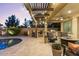 Outdoor patio with bar, outdoor kitchen, BBQ, seating and in-ground pool at 831 E Tonto Pl, Chandler, AZ 85249