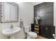 A stylish powder room with a decorative mirror and dark wood accents at 831 E Tonto Pl, Chandler, AZ 85249
