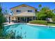 Beautiful backyard featuring a sparkling pool, lush landscaping, and a covered patio, perfect for outdoor entertaining at 8419 E Stella Ln, Scottsdale, AZ 85250