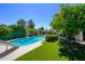 Picturesque backyard showcasing a sparkling pool, a seating area, and mature landscaping, perfect for outdoor living at 8419 E Stella Ln, Scottsdale, AZ 85250