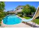 Lush backyard showcasing a large pool with a slide, perfect for summer fun, and mature landscaping that provides shade at 8419 E Stella Ln, Scottsdale, AZ 85250
