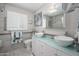 Bright bathroom showcasing a modern double vanity with vessel sinks, stylish fixtures, and marble tile at 8419 E Stella Ln, Scottsdale, AZ 85250