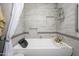 Relaxing bathroom features a white bathtub with tile surround and convenient built-in shower niche at 8419 E Stella Ln, Scottsdale, AZ 85250