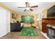 Versatile bedroom with unique forest mural, ceiling fan, and cozy daybed for guests or relaxation at 8419 E Stella Ln, Scottsdale, AZ 85250