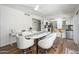 Bright dining area with modern table and chairs, flowing seamlessly into the kitchen at 8419 E Stella Ln, Scottsdale, AZ 85250