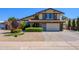Beautiful two-story home featuring manicured landscaping and an attached garage at 8419 E Stella Ln, Scottsdale, AZ 85250