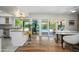 Kitchen featuring white cabinets, granite countertops, stainless steel appliances, breakfast bar, and pool view at 8419 E Stella Ln, Scottsdale, AZ 85250
