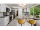 Bright kitchen featuring white cabinets, granite countertops, and stainless steel appliances at 8419 E Stella Ln, Scottsdale, AZ 85250