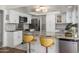 Bright kitchen featuring white cabinets, granite countertops, and stainless steel appliances at 8419 E Stella Ln, Scottsdale, AZ 85250