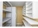 Functional pantry with ample shelving and a refrigerator, perfect for organizing groceries and supplies at 8419 E Stella Ln, Scottsdale, AZ 85250