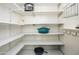 Spacious walk-in pantry with ample shelving for organized storage at 8419 E Stella Ln, Scottsdale, AZ 85250