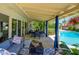 Inviting covered patio with comfortable seating, dining area, and view of the sparkling pool, perfect for outdoor entertaining at 8419 E Stella Ln, Scottsdale, AZ 85250
