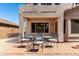 Brick patio with outdoor seating and view of the home's back exterior at 8755 E Portobello Ave, Mesa, AZ 85212