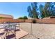 Backyard with gravel and a stone patio with outdoor furniture at 8755 E Portobello Ave, Mesa, AZ 85212