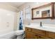Bathroom with wood framed mirror and white cabinets at 8755 E Portobello Ave, Mesa, AZ 85212